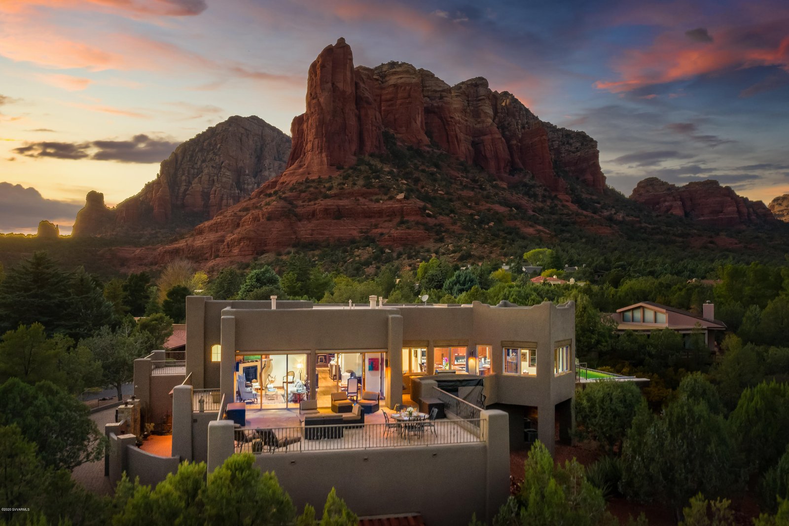 Luxury Sedona home at dusk against red rock formations